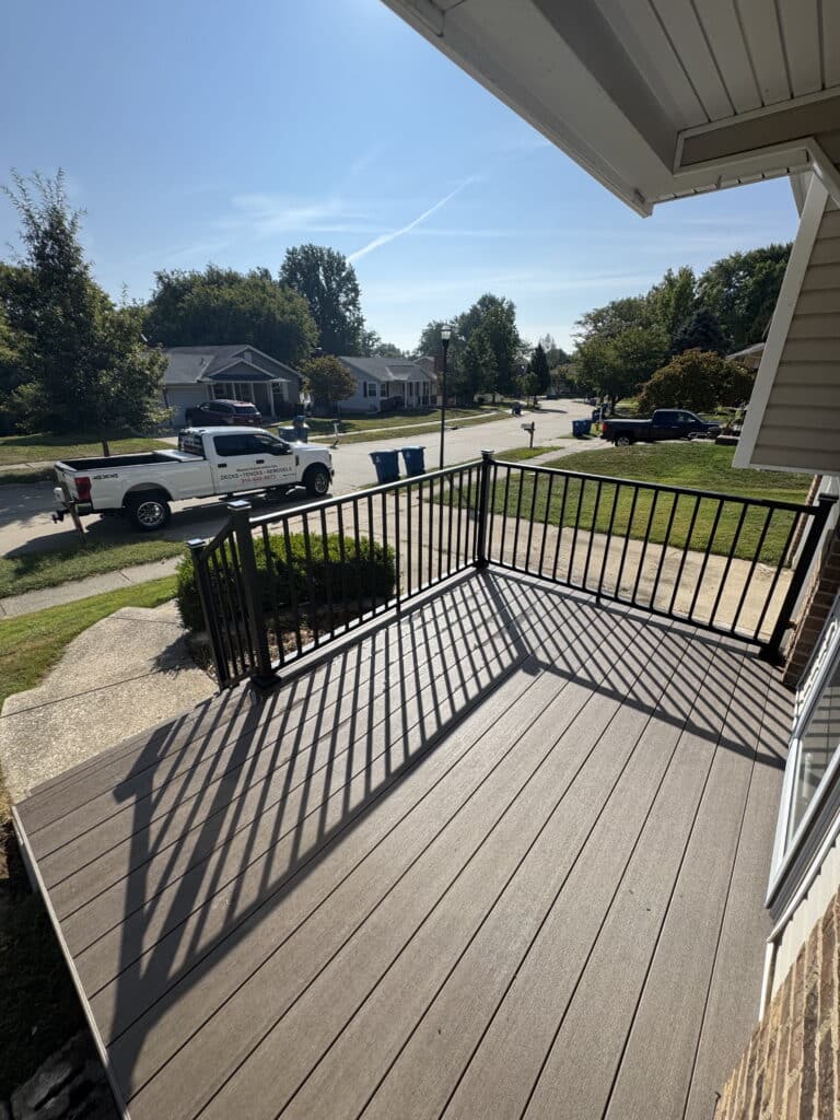 Close view of black aluminum railing with square balusters on a composite deck