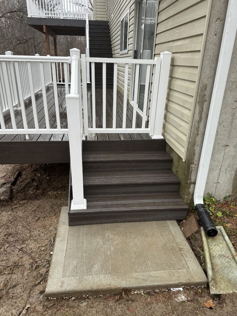 White vinyl railing posts and composite stair treads