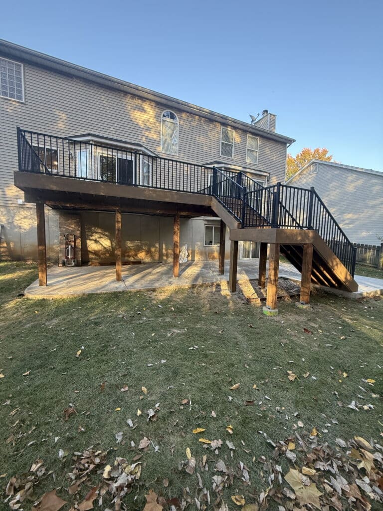 Elevated composite deck with black aluminum railing and stair rail