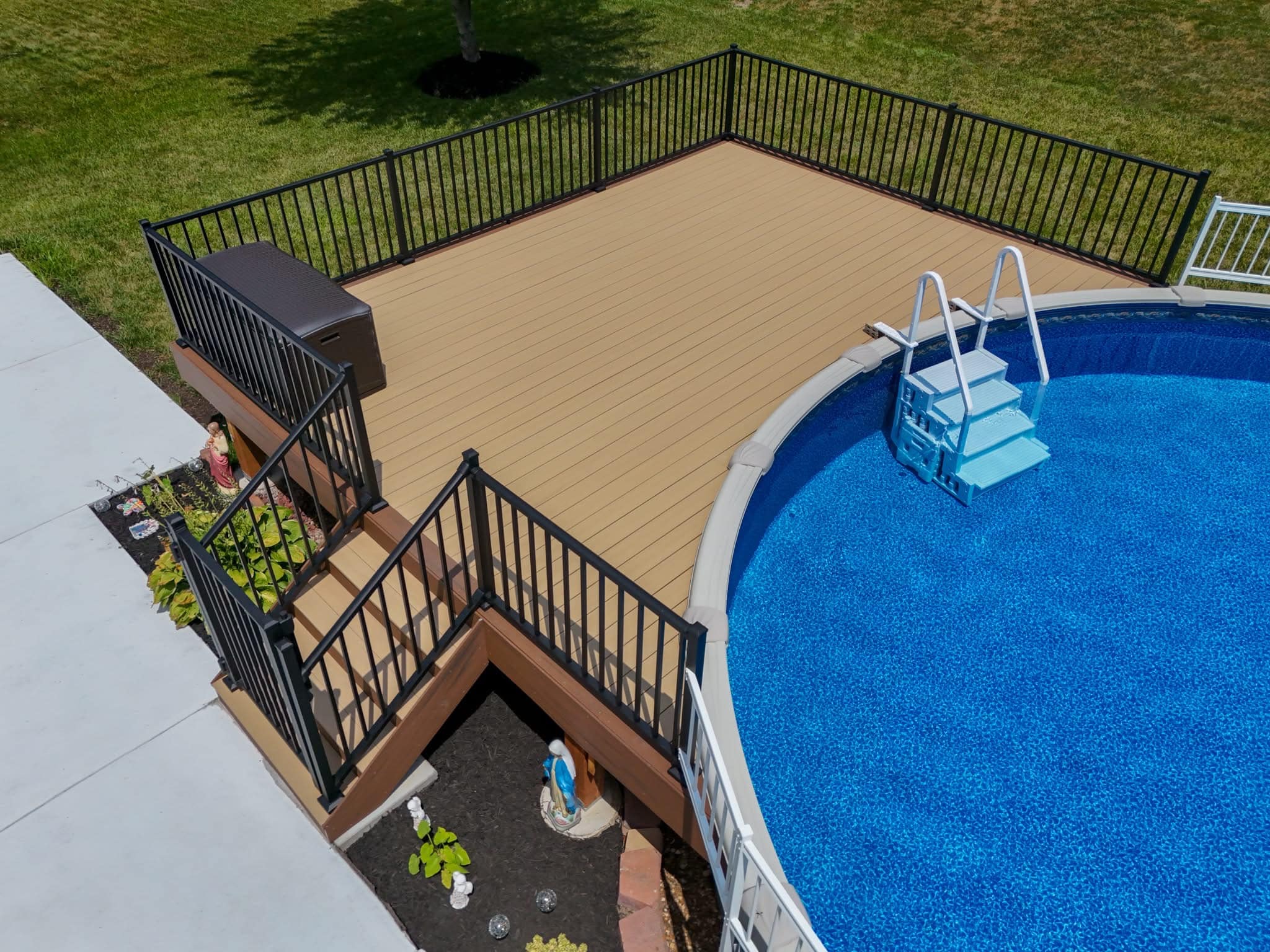 Close view of composite pool decking and black aluminum railing at the pool edge