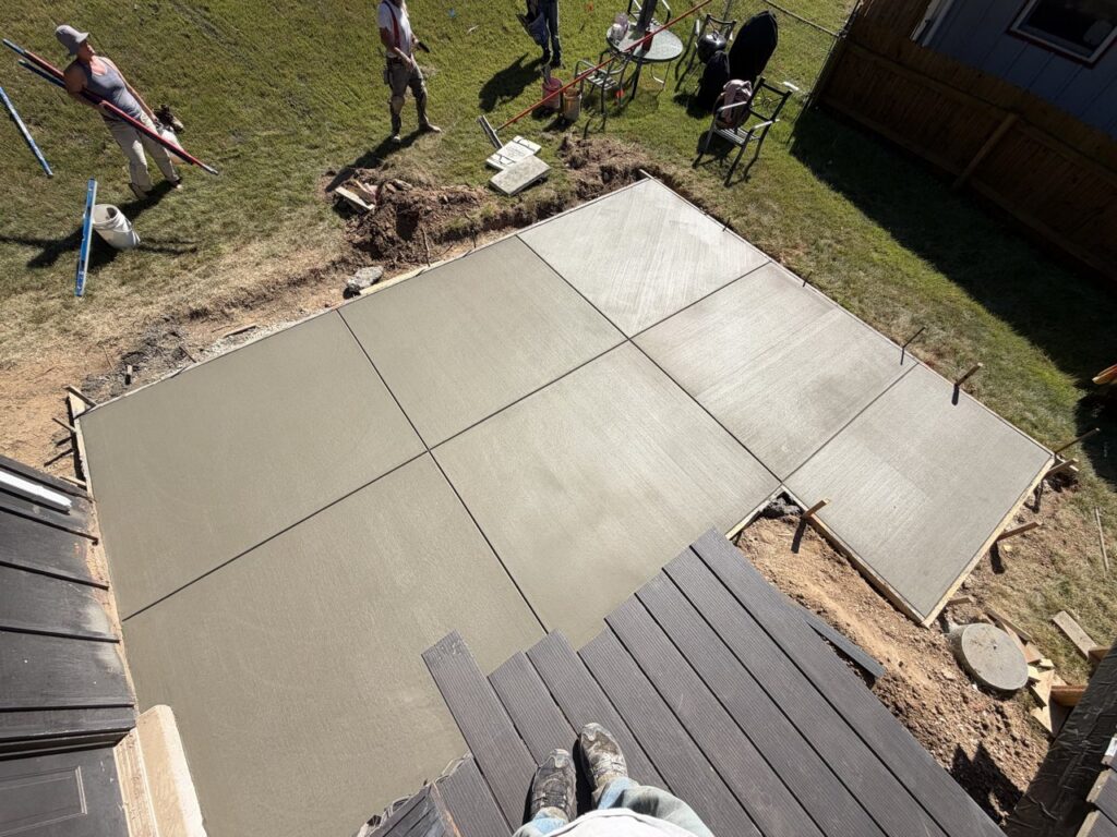New broom-finish concrete patio next to a composite deck, St. Louis MO