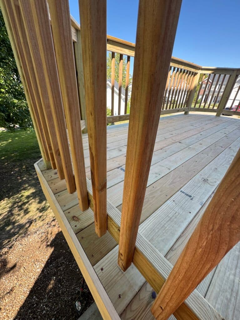 New railing beside the patio door on a revamped deck